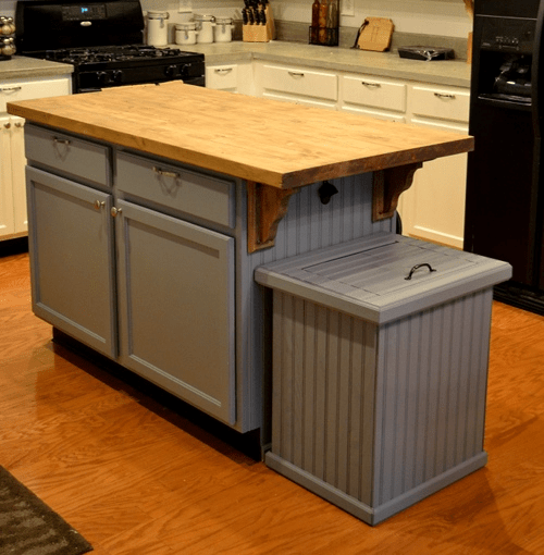 kitchen island with a trash can cabinet